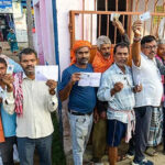Bihar Assembly Elections 2025 women voters turnout record photo Description: Women standing in line at a polling booth in Bihar.