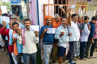 Bihar Assembly Elections 2025 women voters turnout record photo Description: Women standing in line at a polling booth in Bihar.