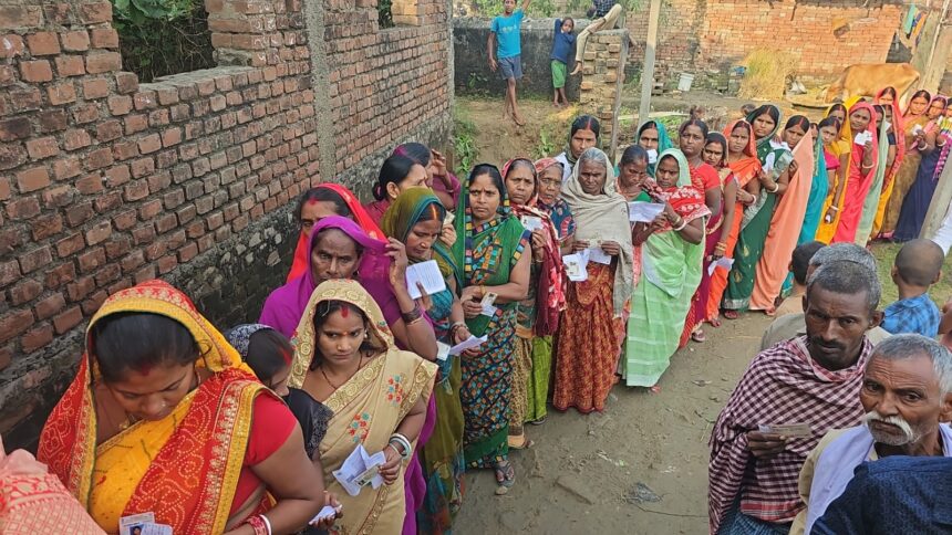 Voters queue outside a rural polling booth in Bihar during Phase-1 polling on 6 Nov 2025.