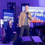 noah-wyle-performs-a-physical-examination-on-the-hollywood-bowl-stage-as-part-of-netflix’s-prank-feature-show