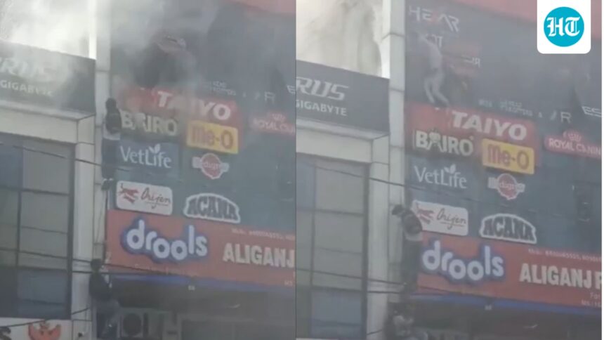 people-cling-to-ropes-as-fire-rips-through-lucknow-building,-killing-15:-video