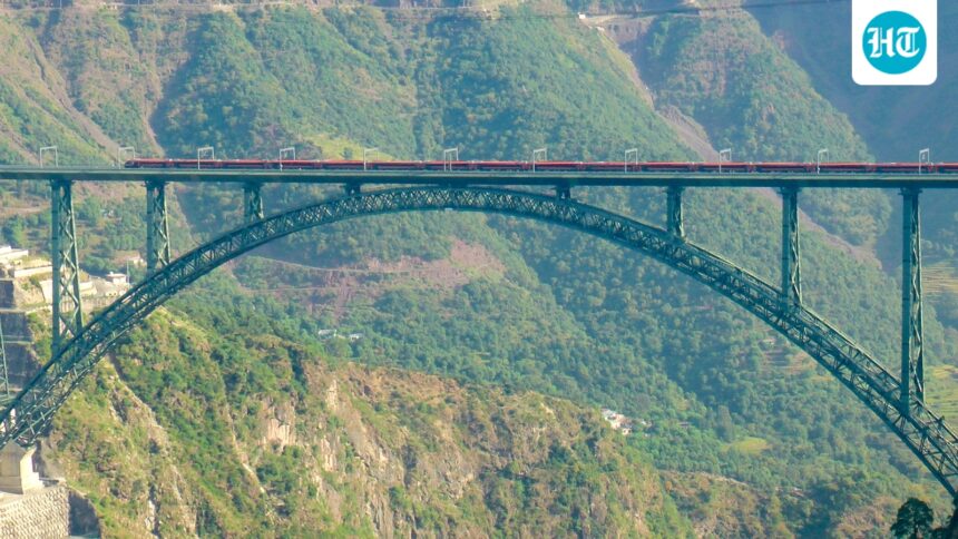 in-a-first,-vande-bharat-express-crosses-world’s-highest-chenab-rail-bridge-at-100-kmph-|-video